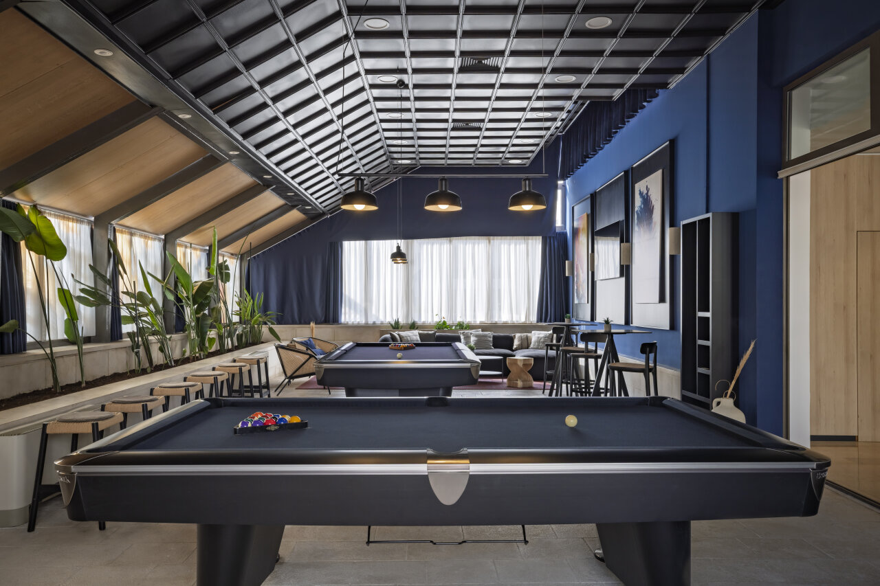 Hotel game room with two pool tables, lounge seating, and pendant lights at Valamar Meteor Hotel.