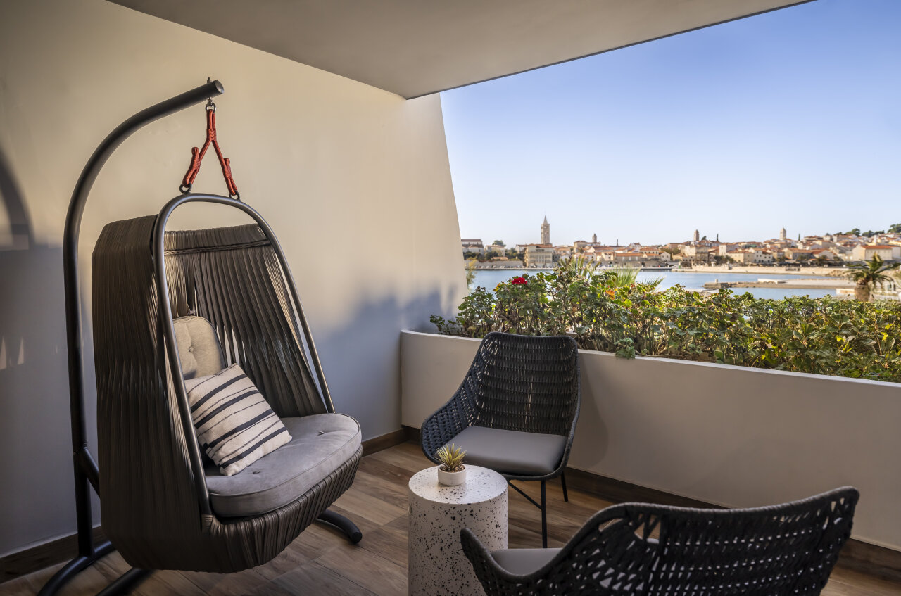  Balcony with hanging chair and sea view of Rab's old town.