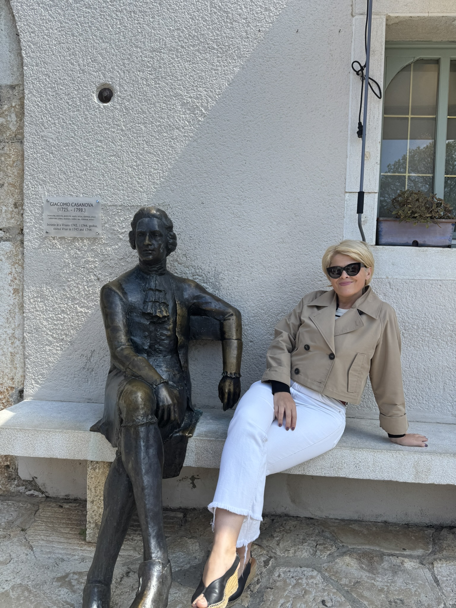 Sculpture of Giacomo Casanova on a bench by the Small City Gate Sculpture of Giacomo Casanova on a bench by the Small City Gate