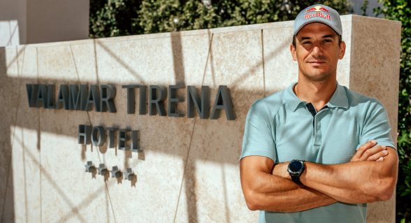 A man in a light blue polo shirt standing with arms crossed in front of the Valamar Tirena Hotel sign.