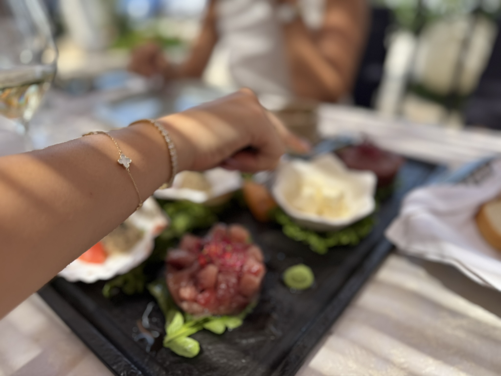 A person reaching toward a gourmet seafood platter A person reaching toward a gourmet seafood platter