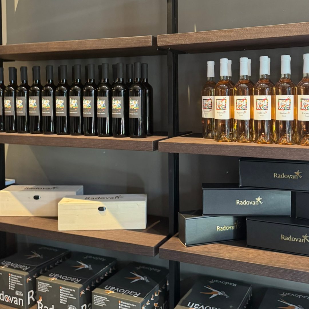 Shelves displaying Radovan Wines bottles and elegant gift boxes inside the winery shop. Shelves displaying Radovan Wines bottles and elegant gift boxes inside the winery shop.