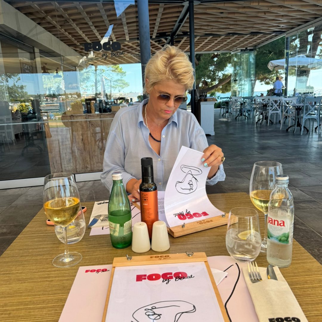 A woman in the Fogo by Bekal restaurant is having a look at the menu. A woman in the Fogo by Bekal restaurant is having a look at the menu.