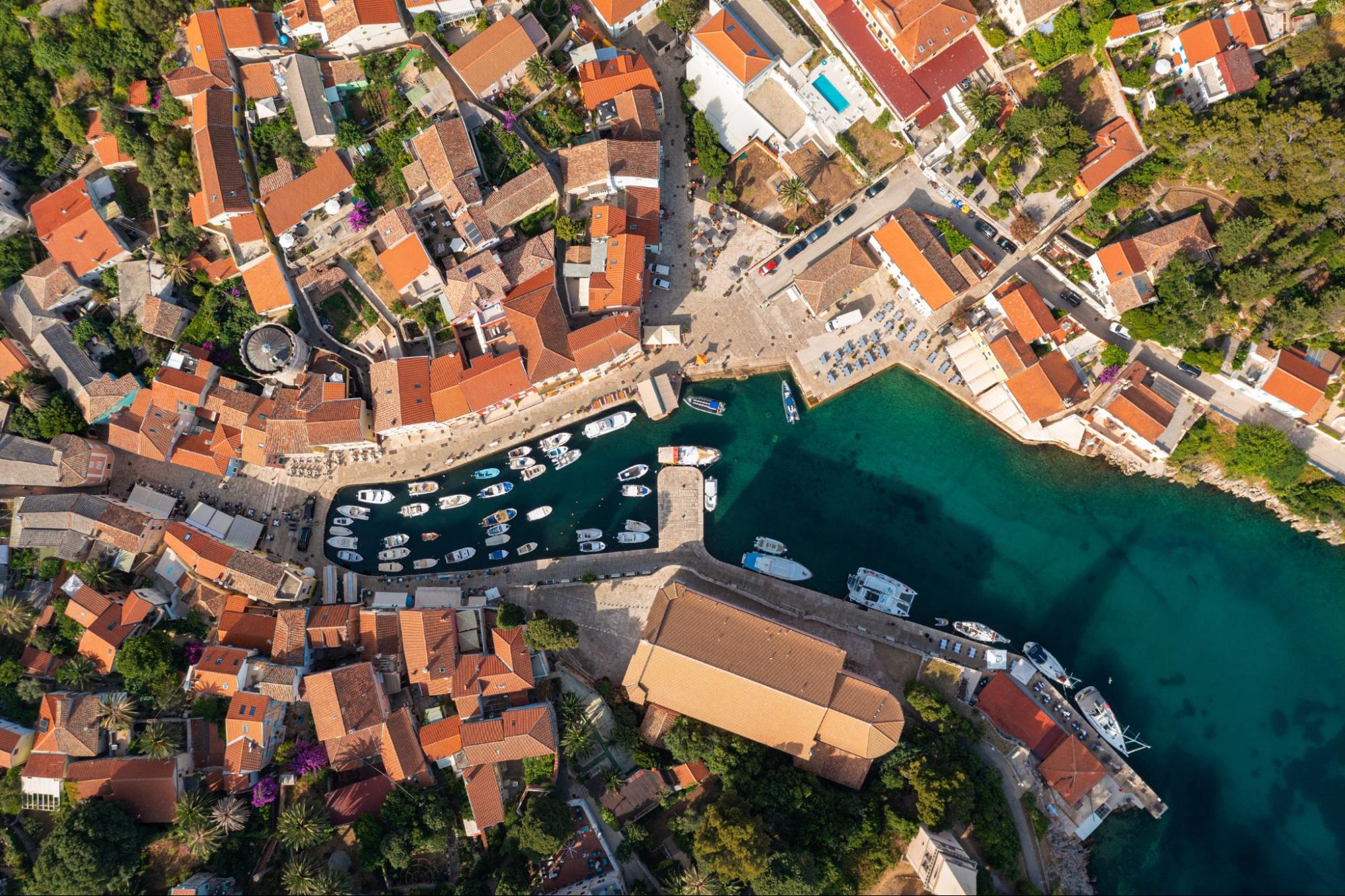 Aerial view of the harbourfront in Veli Lo&scaron;inj with boats and a seaside promenade