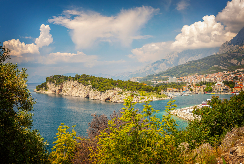 Scenic view of Sveti Petar Peninsula and Makarska town with Biokovo mountain in the background. Scenic view of Sveti Petar Peninsula and Makarska town with Biokovo mountain in the background.