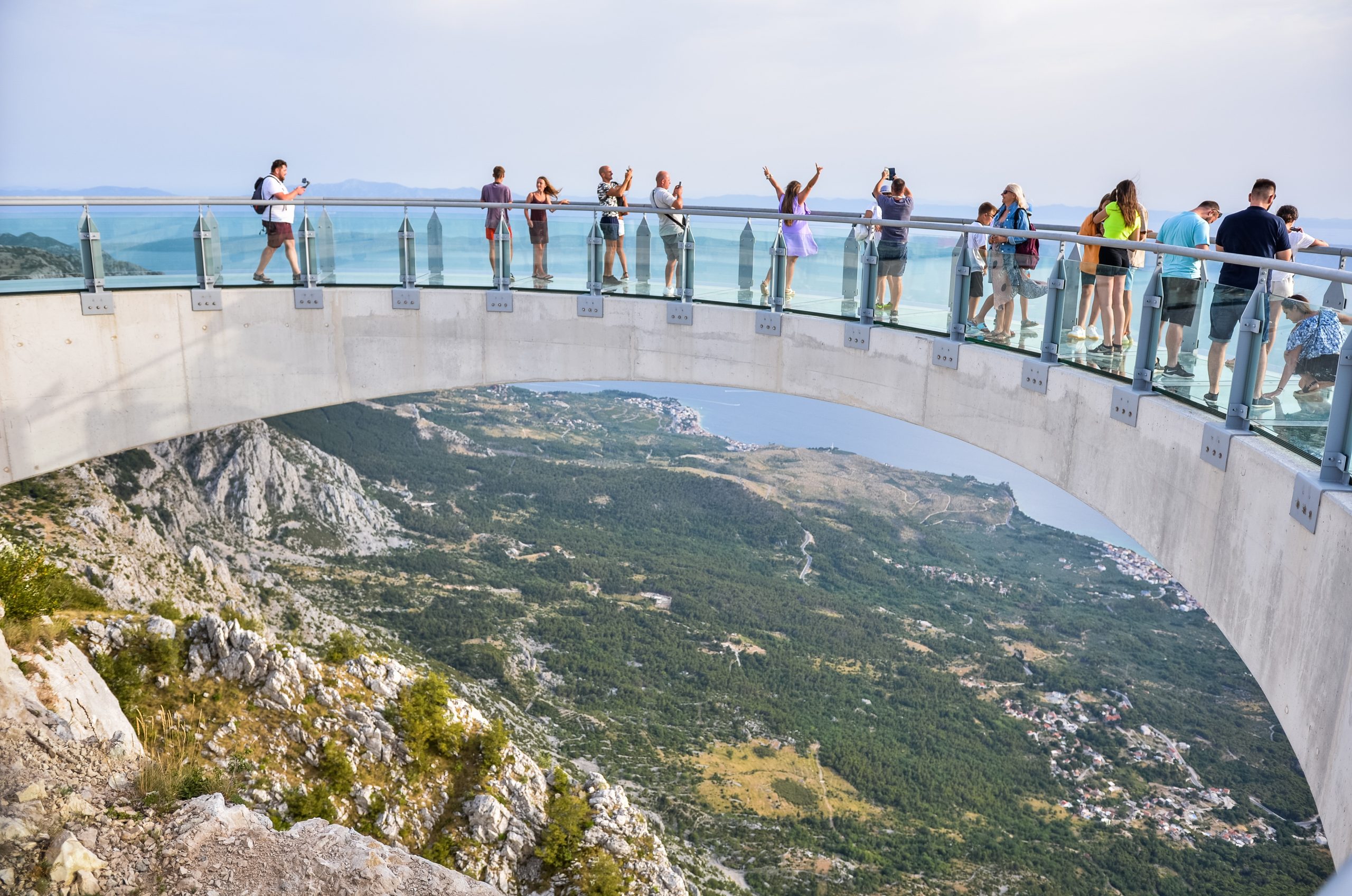 People enjoying the Biokovo Skywalk glass platform with panoramic views over Makarska and the Adriatic coast.  People enjoying the Biokovo Skywalk glass platform with panoramic views over Makarska and the Adriatic coast.