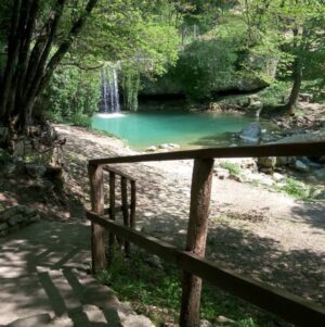 Gologorički Dol waterfall in Istria with turquoise pool and forest path.