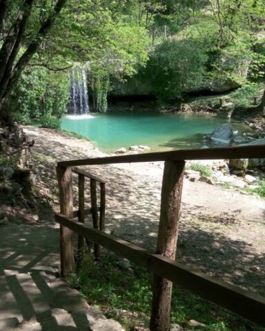 Gologorički Dol waterfall in Istria with turquoise pool and forest path.