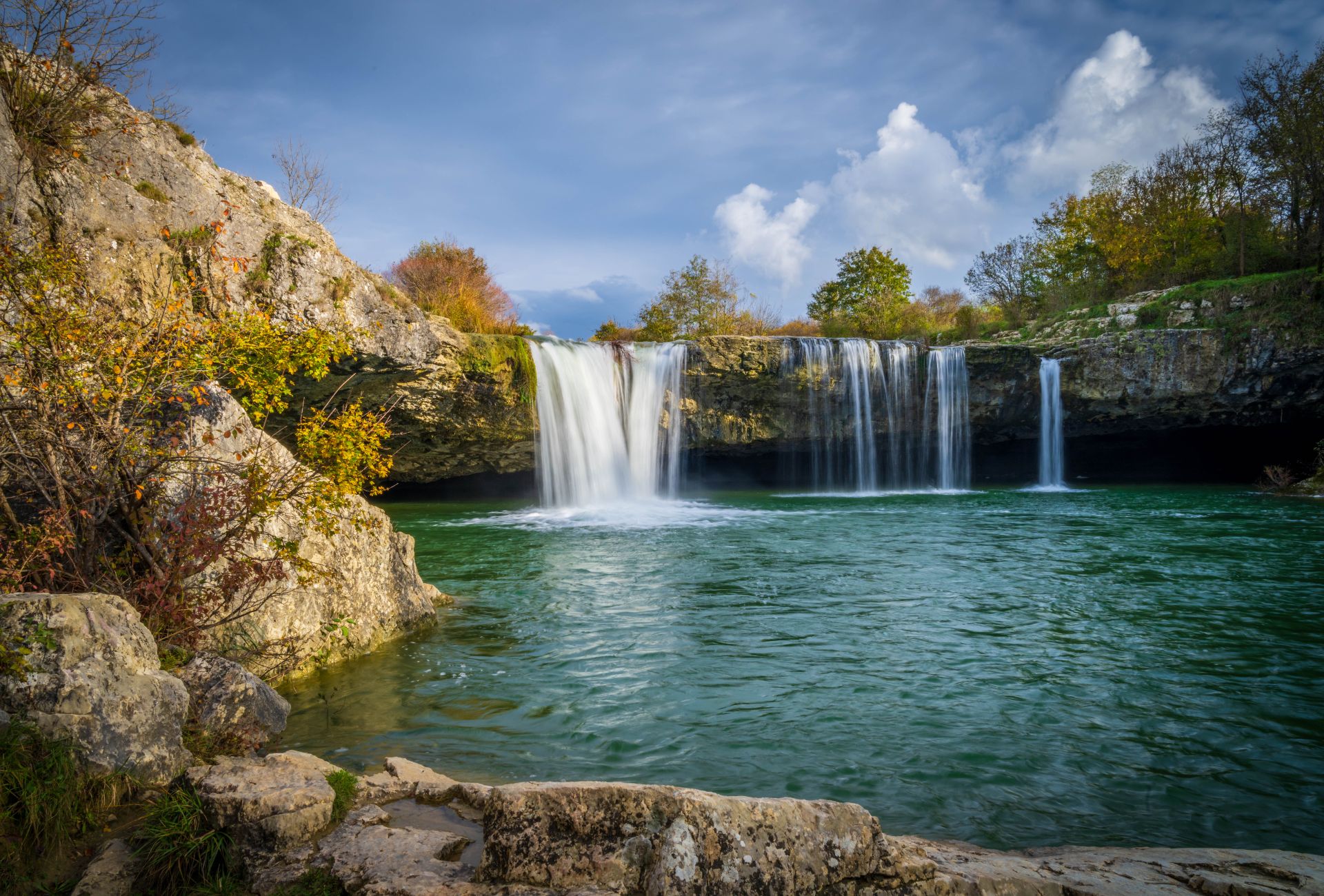 Zarečki Krov waterfall near Pazin, cascading into a deep emerald pool. 
