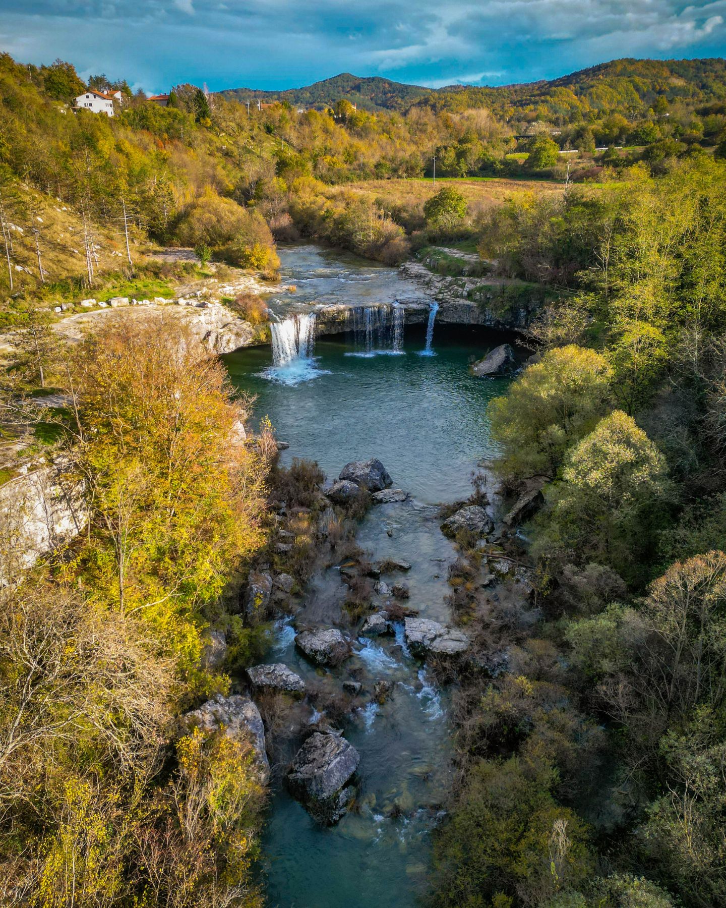 Zarečki Krov waterfall near Pazin, surrounded by lush forest and rocky terrain 