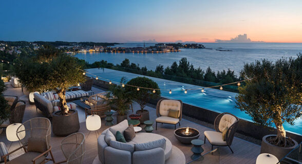 Rooftop Bar at Pical with olive trees, fire pits, and an infinity pool overlooking the sea and Poreč at sunset.