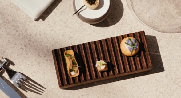 Gourmet bite-sized appetisers served on a wooden tray at Spinnaker restaurant.