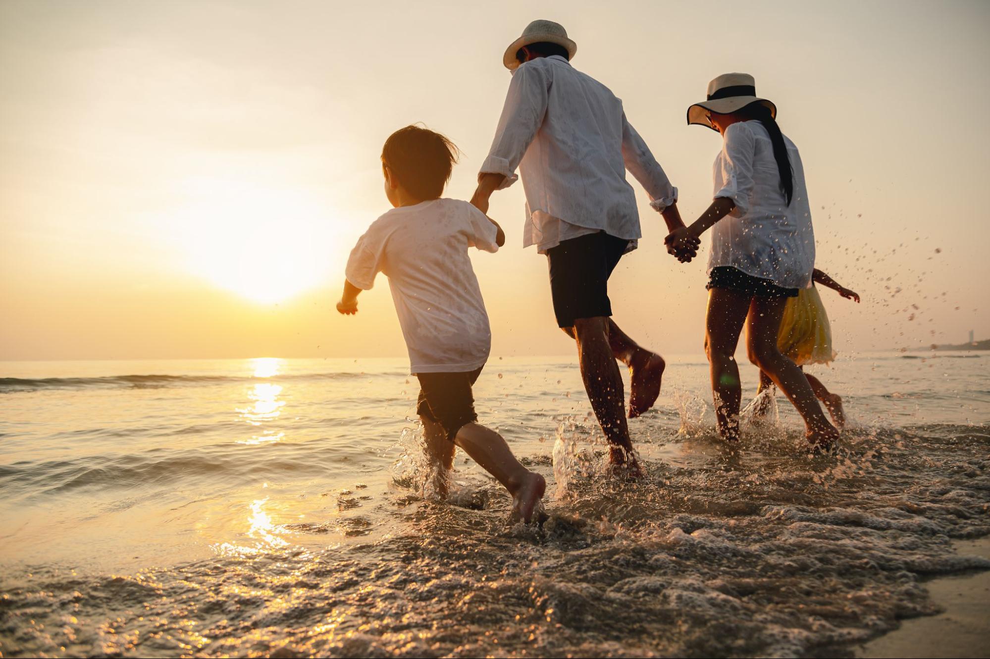 Family walking along the Adriatic shoreline at sunset during a summer holiday in Croatia Family walking along the Adriatic shoreline at sunset during a summer holiday in Croatia
