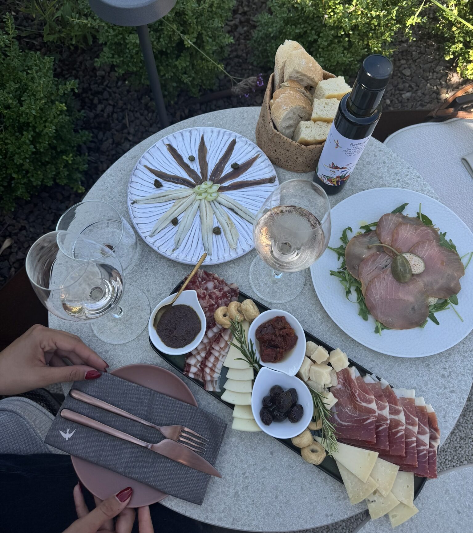 Sunlit terrace at Radovan Winery with a set table for wine and food tasting.
