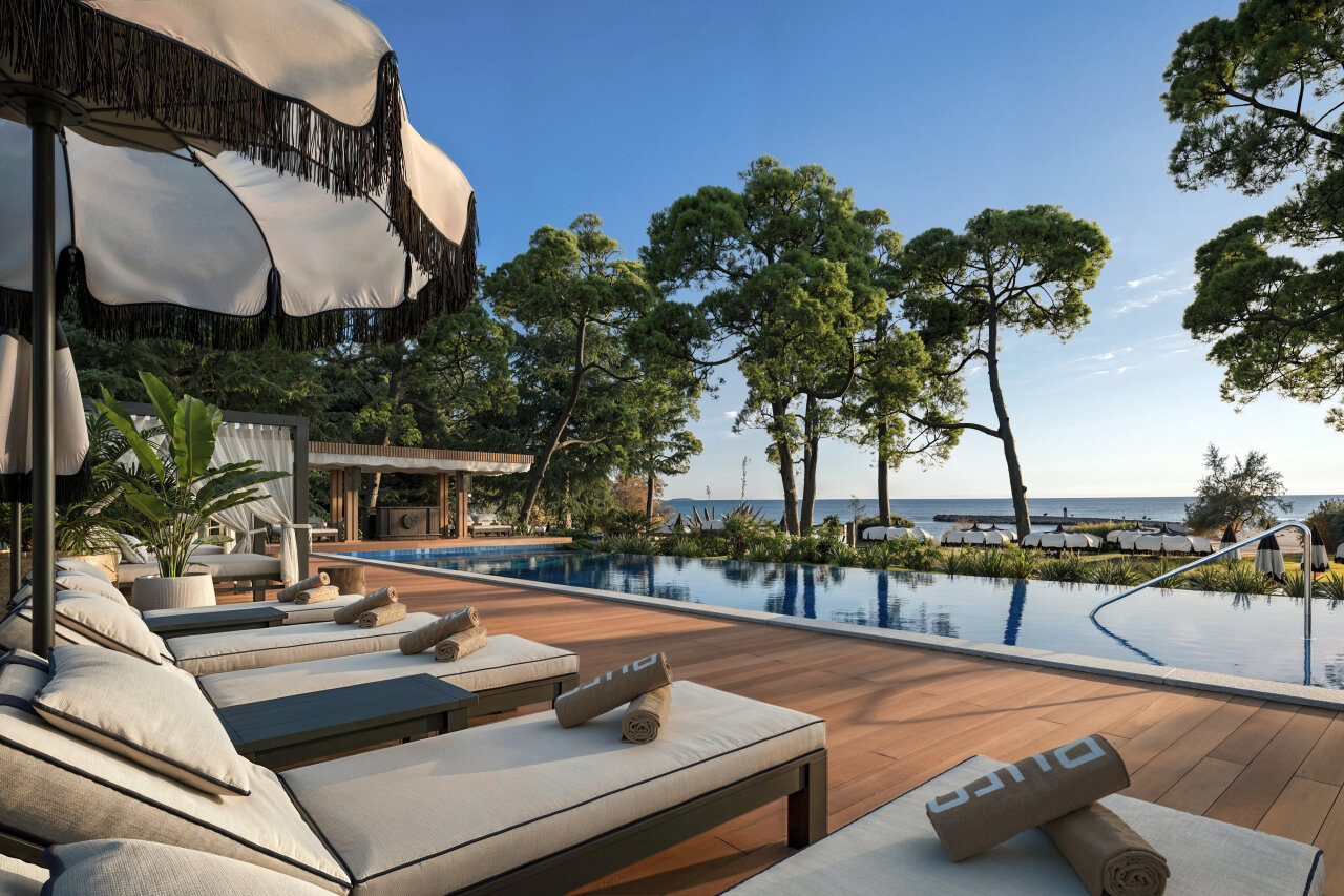 Infinity pool at Purobeach Poreč with sea views and sun loungers