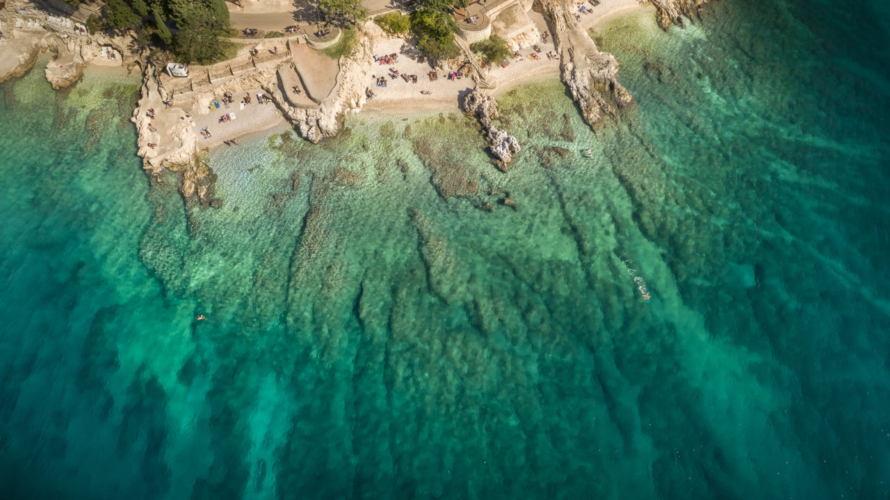 Rabac&rsquo;s beaches with crystal-clear water seen from above